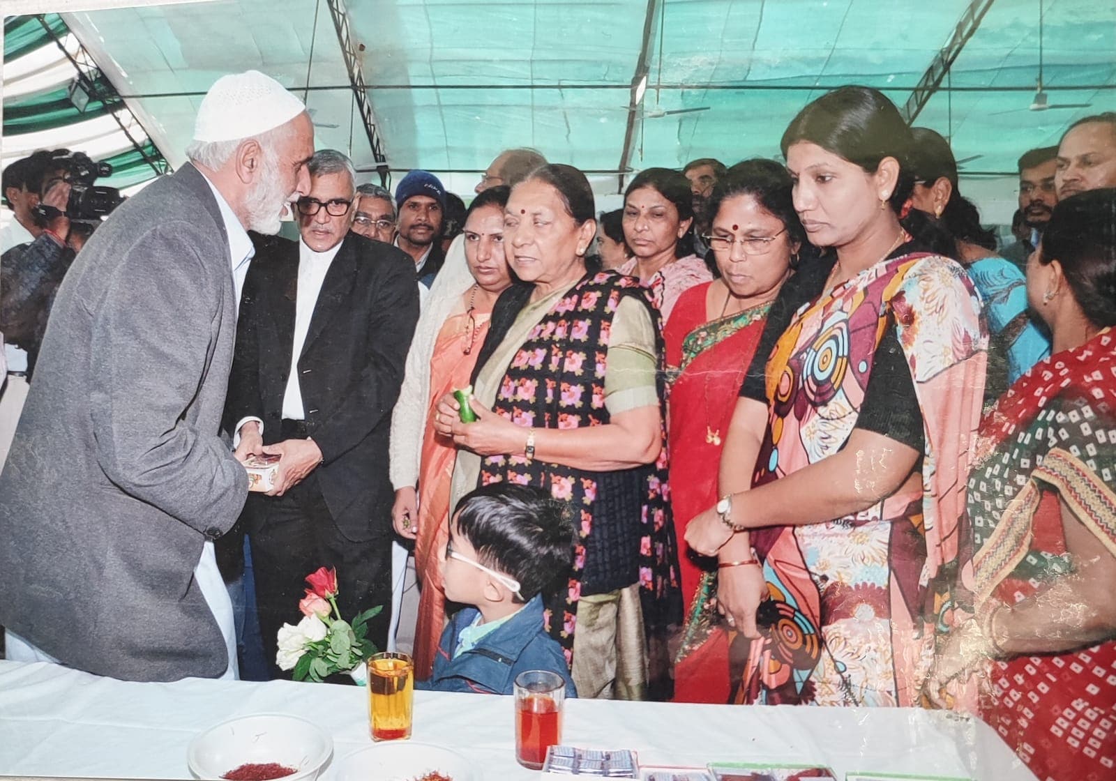 Our family elder presenting Kashmiri saffron to visiting women dignitaries at an exhibition stall