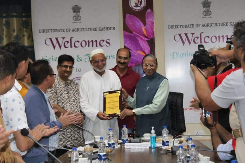 Receiving a commemorative plaque from a dignitary at the Directorate of Agriculture Kashmir