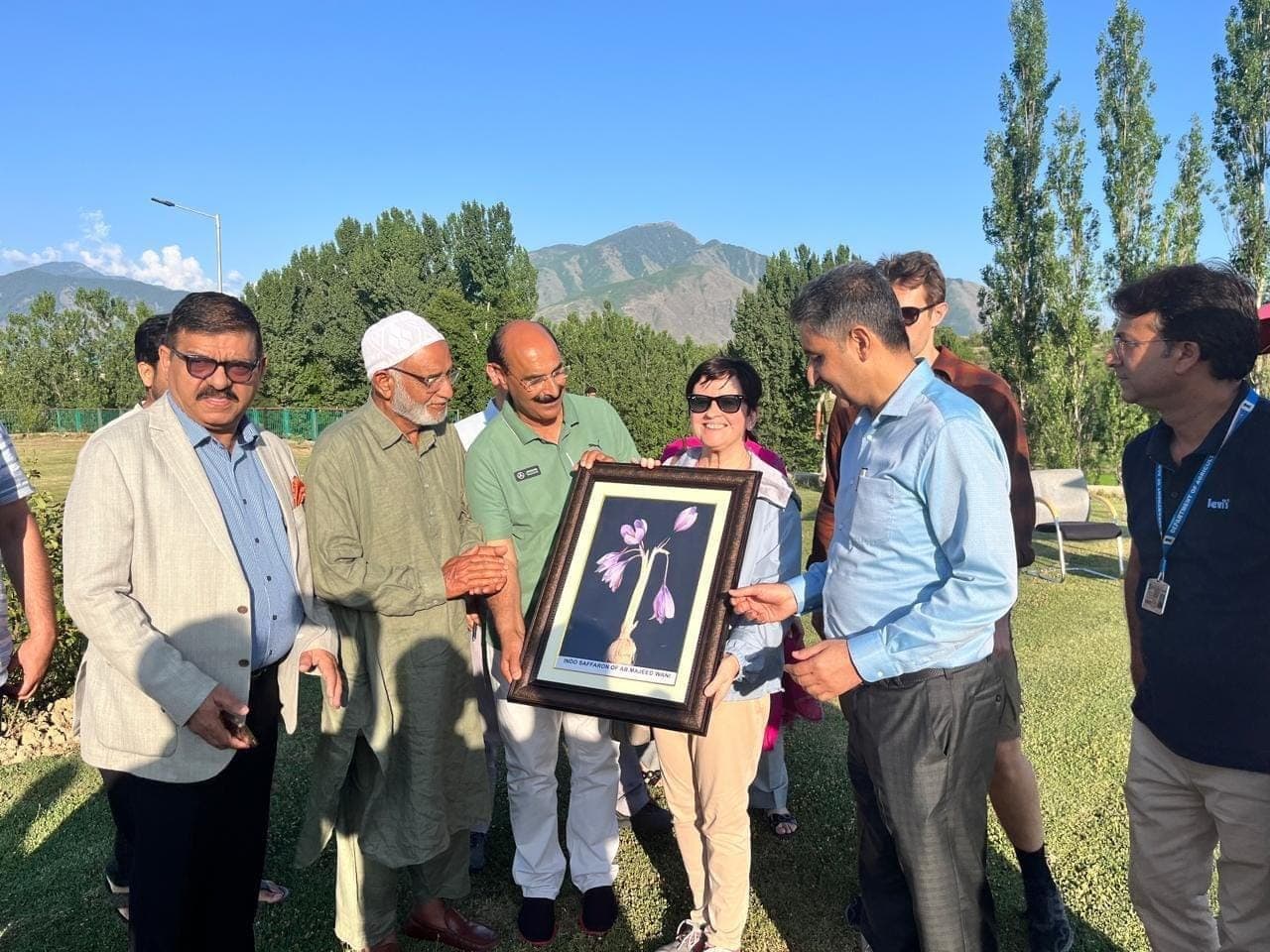 Presenting our framed saffron flowers to an international delegation visiting the Pampore saffron fields