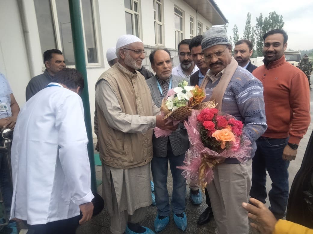 Our family elder welcoming visiting officials with flower bouquets at our saffron facility
