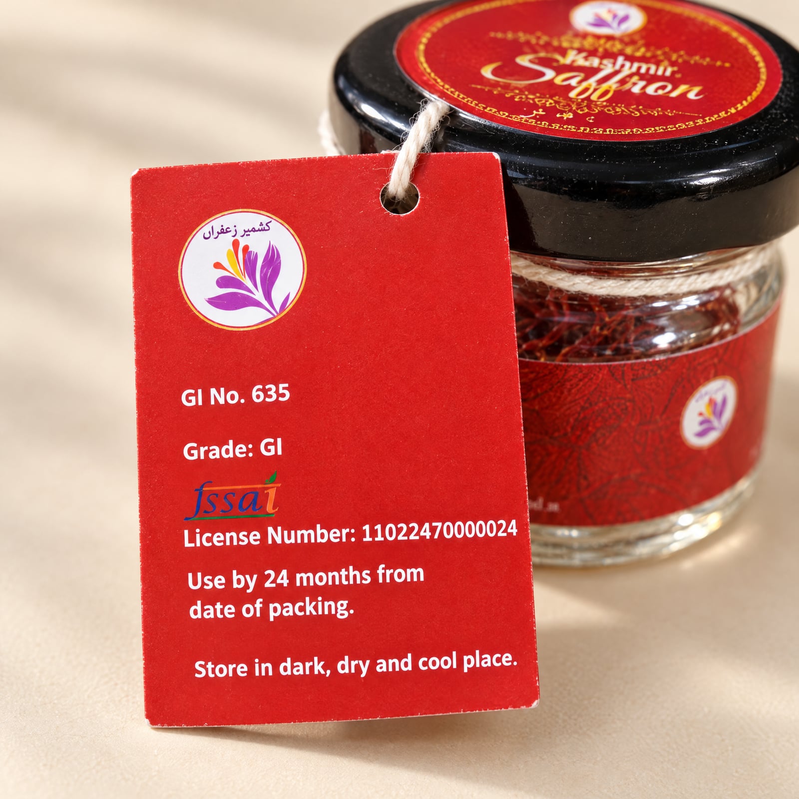 The back of the red hang tag in front of the jar, printed GI No. 635, Grade: GI, the FSSAI licence number and use-by and storage lines