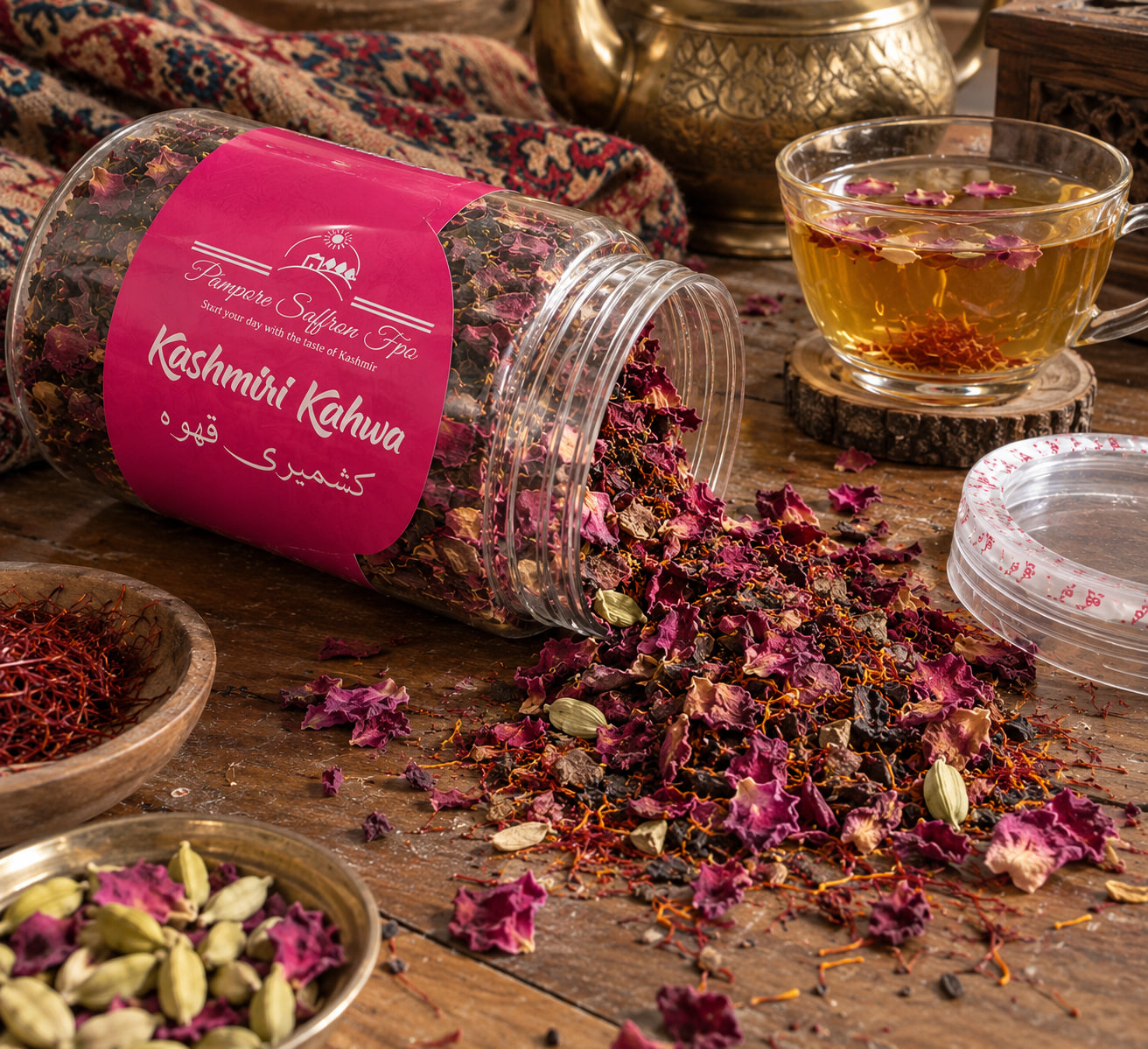 The kahwa jar tipped on its side on a wooden table, rose petals, cardamom and saffron spilling out, a glass cup of kahwa behind