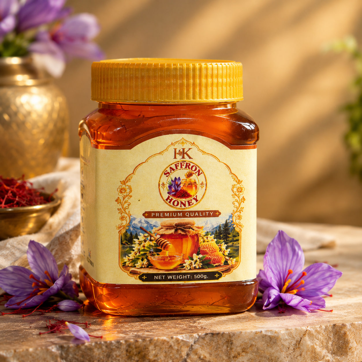 A 500 g jar of Kashmiri Saffron Honey with a yellow lid on a stone ledge in warm light, crocus flowers at its base and a brass bowl of saffron threads to the left