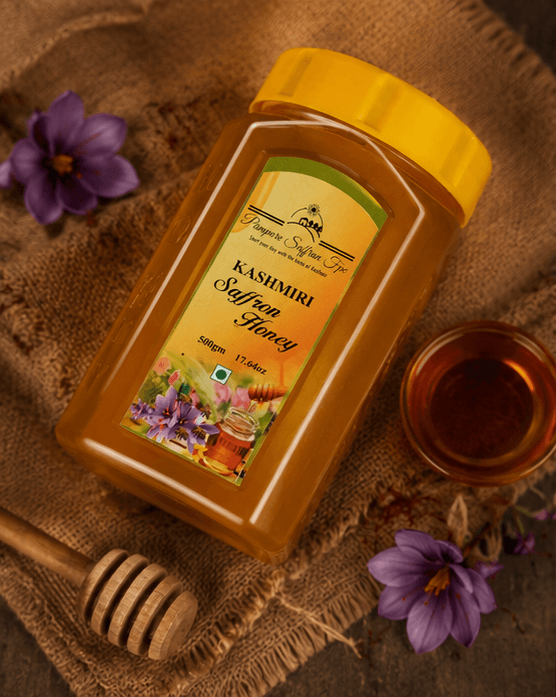 The saffron honey jar on hessian, photographed from above with a wooden dipper, a glass of honey and two crocus flowers